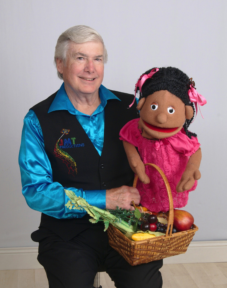 Mr. T and a puppet have a basket of vegetables
