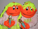 Two similarly-colored puppets holding candles