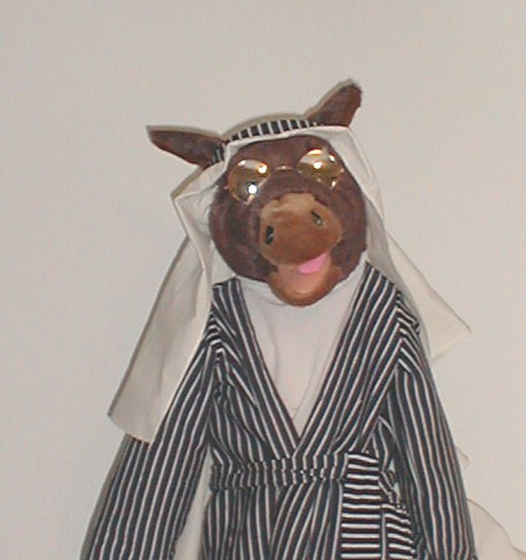 A donkey puppet dressed as a shepherd