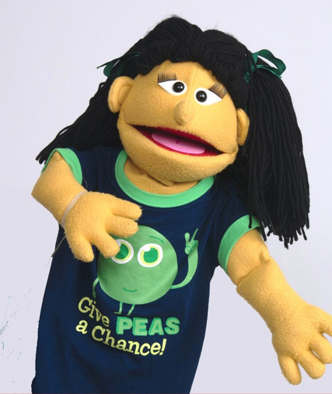 A puppet in a "peas" T-shirt