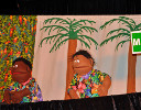 Two puppets in hawaiian shirts sing